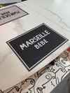 Sets de table personnalisés "Marseille Bébé" de la marque française Pôdevache, coloris noir ou blanc, disponible chez I.D DECO en retrait boutique ou en livraison partout en France
